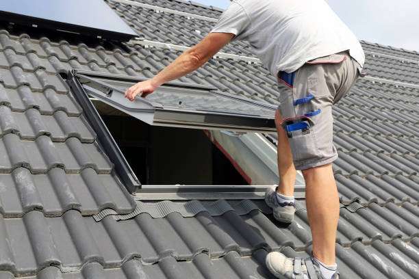 Worker installing a skylight on a tiled roof, emphasizing skylight installation services for enhanced natural light and energy efficiency.