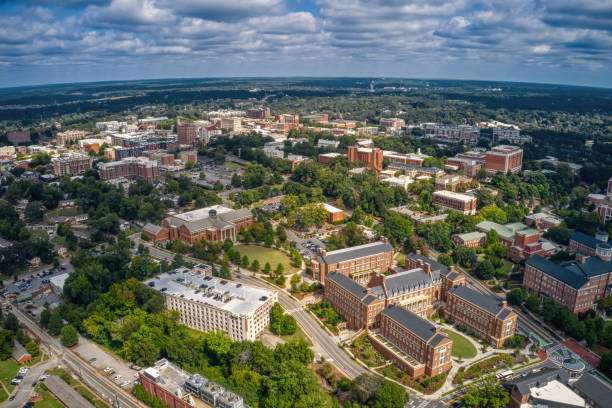 Aerial view of Athens, GA, showcasing a mix of historic and modern buildings, green spaces, and urban development, reflecting the vibrant community and construction opportunities in the area.