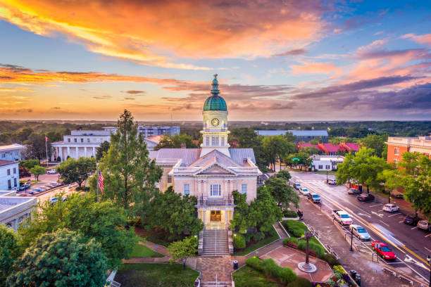 Historic Athens, GA courthouse at sunset, surrounded by trees and vibrant streets, showcasing the city's architectural charm and community atmosphere.