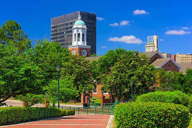 Augusta, GA cityscape featuring historic architecture and modern buildings amidst lush greenery, symbolizing the blend of tradition and progress in the community.