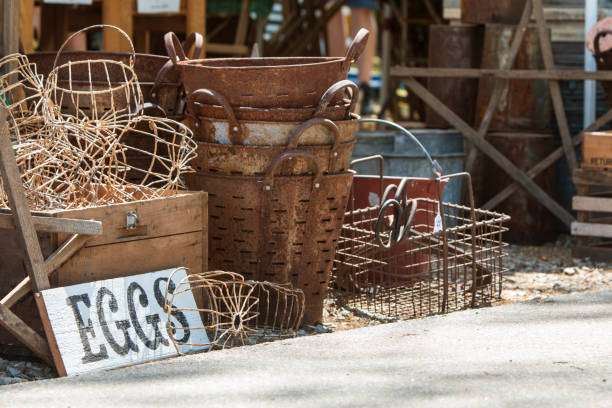 Rustic display of vintage baskets and wire containers with a sign reading "EGGS," reflecting the charm of Braselton, GA's community markets and artisanal craftsmanship.