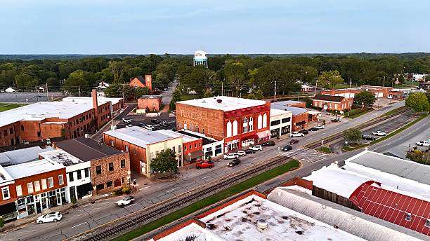 Aerial view of downtown Royston, GA, showcasing historic brick buildings, local shops, and tree-lined streets, reflecting community pride and charm.