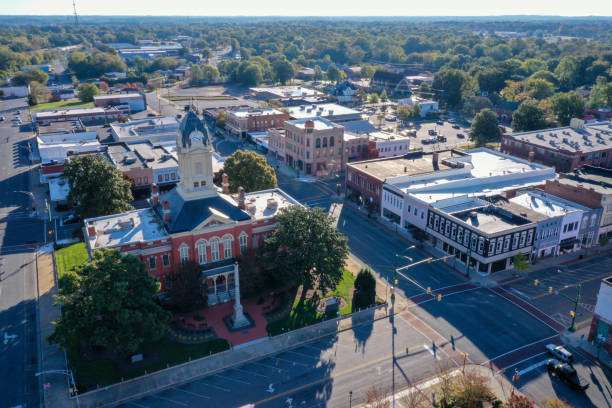 Aerial view of downtown Watkinsville, GA, showcasing historic buildings, vibrant streets, and green spaces, highlighting the community's charm and appeal for homeowners considering renovations and upgrades.