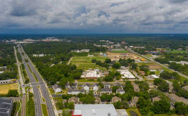 Aerial view of Gainesville, GA, showcasing residential neighborhoods, new construction sites, and surrounding greenery, emphasizing the area's growth and community development.