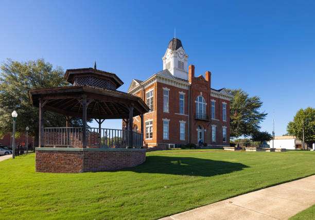 Historic building in Statham, GA, featuring a gazebo in the foreground and lush green lawn, representing the town's community character and charm.