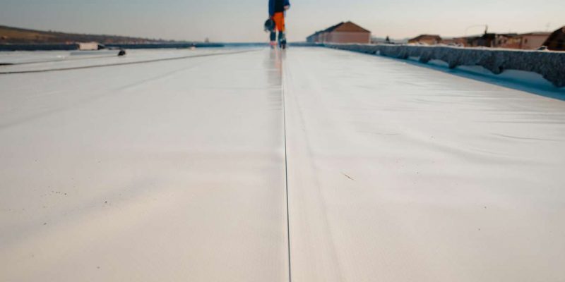 Waterproofing and insulation at construction site, waterproofing membrane preventing water penetration. Exterior vapor barrier for roof.