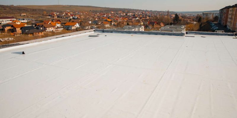 Flat white TPO roofing system on a commercial building